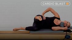 a woman in black shirt laying on top of a yoga mat with the words cardio blast above her