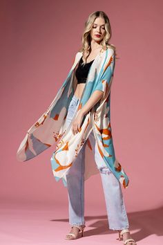 The bohemian wardrobe staple every woman needs! This stunning long silhouette kimono features breezy side slits, half-length kimono sleeves, and a relaxed oversize fit. Throw it on at the beach for a quick cover-up or style it with your favorite jeans and a band tee for a cool everyday look. The gorgeous multicolor print will have you turning heads wherever you go! 100% Viscose Sweeping watercolor print Relaxed, oversize fit 1/2 length kimono sleeve Mid-length Side slits Open front One size fits most Length: 36" Width 40" Chic Spring Unlined Cover-up, Chic Unlined Spring Cover-up, Summer Beach Cover-up Kimono, Summer Festival Kimono With Open Front, Summer Festival Open Front Kimono, Spring Beach Cover-up Unlined, Breezy Spring Cover-up With Relaxed Fit, Lightweight Oversized Cover-up For Spring, Bohemian Flowy Unlined Cover-up