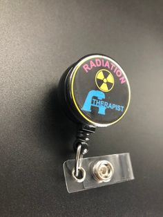 This unique retractable badge holder is adorable and useful. A great gift for any Radiation Therapist! These will be made with a belt clip back. If you prefer a swivel clip, let me know in the notes to seller section when checking out. Thank you!! :) Adjustable Black Retractable Badge Holder, Black Adjustable Retractable Badge Holders, Black Badge Reel With Swivel Clip As A Gift, Black Retractable Badge Holders As Gift, Black Retractable Badge Reel For Gift, Radiation Therapist Gifts, Radiation Therapist, Xray Tech, Retractable Badge Holder