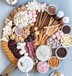 a platter filled with lots of different types of snacks and desserts on top of each other