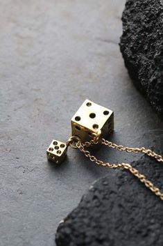 Small and Big Dices Charm Necklace by Defy. The jewelry is designed to have unique style and beautiful details. - The Small Dice dimensions : approx. 0.6 x 0.6 cm. - The Big Dice dimensions : approx. 1.2 x 1.2 cm. - The necklace chain length : please choose from our options. **Shipping to World Wide** - Please allow us to prepare the item and parcel between 3-5 working days. (Between 7-10 working days For Special items / Sterling Silver 925) - All items will be sent by Thai Registered Airmail. T Symbolic Dangle Charm Necklaces As Gift, Symbolic Metal Jewelry With Box Chain, Unique Charm Necklace As Gift, Metal Clavicle Chain Jewelry For Gifts, Unique Brass Jewelry Gift, Unique Brass Jewelry For Gifts, Symbolic Metal Clavicle Chain Jewelry, Unique Metal Charm Necklace As A Gift, Metal Jewelry As A Gift