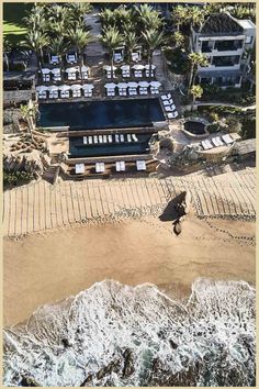 Aerial view of a beachside resort with an organized layout of palm trees and sun loungers around a swimming pool, adjacent to the foamy waves of the sea. Le Blanc Spa Resort Los Cabos, Esperanza Resort Cabo, Tropical Honeymoon, Adventurous Honeymoon, Luxury Honeymoon, Dream Honeymoon, Intercontinental Tahiti Resort & Spa