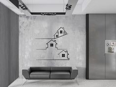 a living room with a couch and a wall decal in the shape of houses