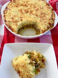 two plates with food on them sitting on a red and white checkered table cloth