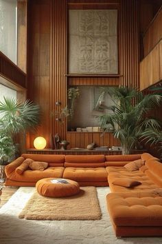 a living room filled with lots of furniture and plants