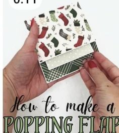 two hands holding up a small box with christmas stockings on it and the words how to make a popping flap