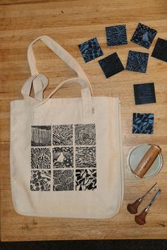 a tote bag, scissors, and other crafting supplies on a table top