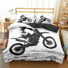 a black and white photo of a person on a dirt bike in the middle of a bed