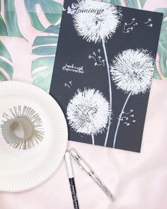 a paper plate and pen next to a dandelion card