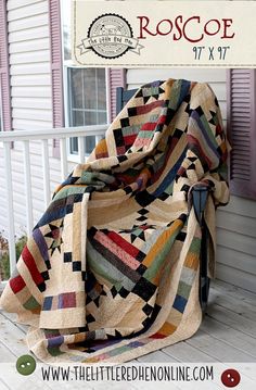 a quilted blanket sitting on the side of a porch next to a sign that says roscoe