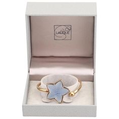 This is part of Chairish’s Costume Jewelry assortment.  Modernist Inspired by the magic of the ocean depths, evokes nature, a theme dear to Maison Lalique. The Raised Blue Textured Starfish of satin & polished crystal subtly captures the light. The French cuff is gold plate over sterling in a Lalique Gift Box. It is a great presentation gift for a loved one!  About the product: *The length is 6.25" *The starfish measures about 1-3/8 inches (3.5 cm) wide and tall. *The name LALIQUE    Is stamped on the back as shown.  Please reference the measurements noted in the description above for the best approximate dimensions. Please reach out to the seller under "Ask the Seller" for specific questions regarding the measurements. Elegant Blue Bracelets For Evening, Elegant Blue Evening Bracelets, Elegant Starfish Bracelet For Gift, Luxury Starfish-shaped Jewelry Gift, Lalique Jewelry, Blue Starfish, Sterling Silver Charm Necklace, Lucite Bracelets, Contemporary Art Deco