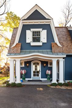 a blue house with white trim and shutters