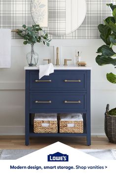 a bathroom vanity with blue drawers and gold handles in front of a mirror above it