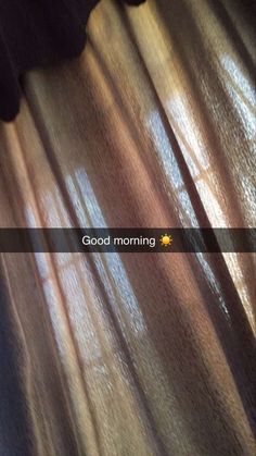 the sun is shining through sheer curtains on a bed room window with text good morning