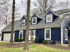 a blue and white house with a sign on it's front door that says lithtfield