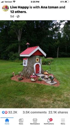 a small tree house with a red roof