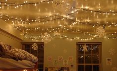 a bedroom with lights hanging from the ceiling and an image of a bed in the background