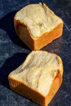 two pieces of bread sitting on top of a table