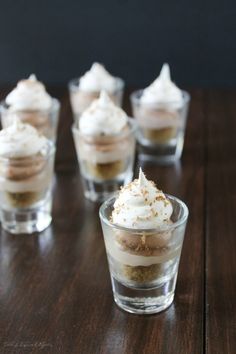 small desserts with whipped cream and nutella cheesecake shooters on a wooden table