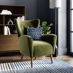 a yellow chair sitting on top of a wooden floor next to a book shelf filled with books