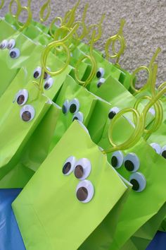 some green bags with googly eyes on them and the words buzz lightyear birthday party