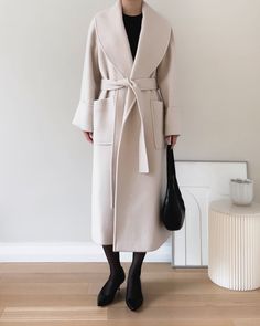 Refined merino wool and alpaca wrap overcoat featuring shawl collar silhouette and folded cuff detail. Handmade. - Oversize cut- Shawl collar- Tie waist- Front flap pockets- Back vent- Fully lined- Measurements: Length 47", Bust 44", Sleeve 30.5"- Outer: Merino Wool 80%, Alpaca 20% Lining: Polyester 100%- Dry clean- Imported Alpaca Coat, Sleeveless Trench, Wool Overcoat, Outerwear Outfit, Cuff Detail, Cashmere Coat, Cool Street Fashion, Shawl Collar, Feminine Style