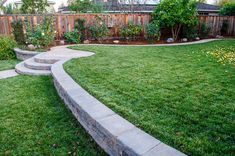 a backyard with green grass and stone steps