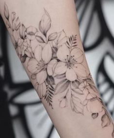 a woman's arm with flowers on it