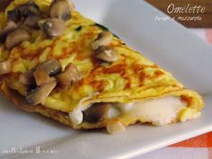 an omelet with mushrooms is on a white plate