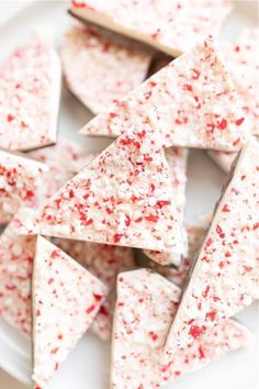 red and white sprinkles are arranged in triangle shapes on top of a plate