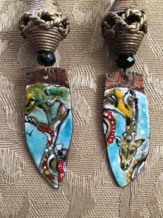 A beautiful giraffe, depicted in enamel by a talented artist, with a complementary enameled component, dangles from metal African beads, with agate, labradorite, unikite, etc.   Ear  friendly niobium shepherd hooks suspend these one of a kind beauties. If you love giraffes, these are for you! Hand Painted Bohemian Enamel Jewelry, Bohemian Hand-painted Enamel Jewelry, Bohemian Hand Painted Enamel Jewelry, Artisan Enamel Dangle Jewelry, Artisan Hand Painted Enamel Jewelry, Artisan Enamel Hand Painted Jewelry, Artistic Hand Painted Enamel Jewelry, Artistic Enamel Earrings, Unique Hand-painted Enamel Jewelry