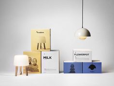 three different types of lamps and boxes on the floor, one with a light bulb hanging over it