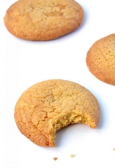 three cookies that have been cut in half on a white surface with one cookie missing