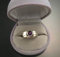 Amethyst natural 6mm round stone is deepest color. Well cut and eye-clean natural stone from Nigeria weighs a little over 1ct. Bezel set with forged tapered multidimensional band. Specify your size at check-out. Amethyst Birthstone Ring With Round Stone, Amethyst Ring With Round Stone, Amethyst Solitaire Round-cut Ring, Amethyst Solitaire Rings, Amethyst Solitaire Ring With Round Stone, Amethyst Rings With Bezel Setting And Round Cut, Modern Amethyst Rings In Round Shape, Amethyst Ring With Round Center Stone As Gift, Amethyst Ring With Center Stone As Gift