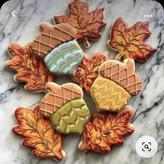 cookies decorated with autumn leaves on a marble surface