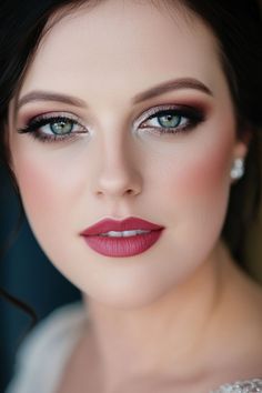 Woman with flawless makeup, defined eyebrows, and bold lipstick. Bride Makeup Dark Lips, Wedding Cat Eye Makeup, Elegant Wedding Makeup Green Eyes, Smokey Eye Wedding Makeup Blue Eyes, Bride Makeup With Glasses, Classy Smokey Eye Makeup, Wedding Makeup Styles Brides, Red Hair Wedding Makeup, Bride Makeup Smokey Eye