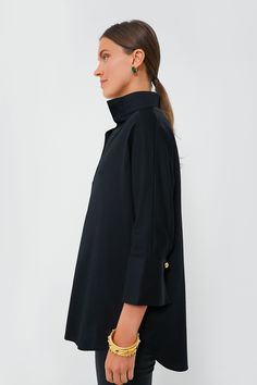 Crafted in a flattering silhouette from a crisp cotton poplin, the Black Willow Blouse is a must-have. Featuring a gold button front half-placket, stand collar, and high-low hem, this pullover pairs easily with everything from denim to leather all year long. Stand collar Three-quarter length sleeves Button cuffs Half-placket Gold buttons High-low hem Cotton poplin fabric Material: 97% Cotton, 3% Spandex Care: Machine wash cold, hang to dry Elegant Tunic With Buttons, Solid Color Stand Collar Tops For Work, Solid Color Blouse With Stand Collar For Work, Elegant Long Sleeve Tunic With Buttons, Stand Collar Blouse With Button Closure For Work, Workwear Blouse With Button Cuffs And Stand Collar, Button-up Tunic For Work, Button-up Tunic For Workwear, Classic Stand Collar Blouse For Fall