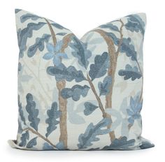 a blue and white pillow with leaves on it