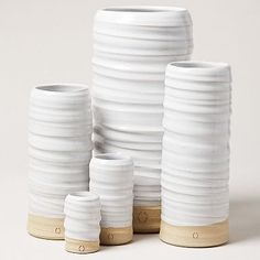 several white vases stacked on top of each other