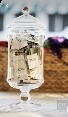 a glass jar filled with lots of cards