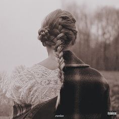 the back of a woman's head with braids in her hair