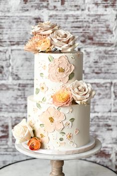 a three tiered cake with flowers on it