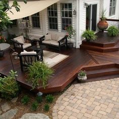 a wooden deck with chairs and tables on it