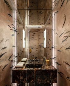 a bathroom with marble counter tops and walls