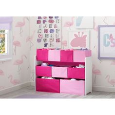 a child's room with flamingos on the wall and pink storage bins