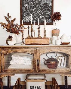 a table with bread and candles on it in front of a chalkboard sign that says bread