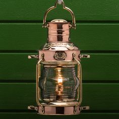 a light hanging from the side of a green wall