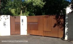 the gate is made out of wood and has two doors on each side that are closed