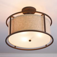 the light fixture is hanging from the ceiling in the living room, which also has a lamp shade on it