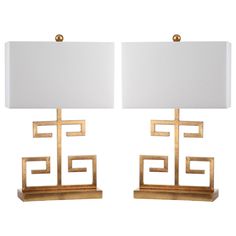 a pair of gold table lamps with white shades